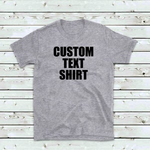 May include: A gray t-shirt with the text "CUSTOM TEXT SHIRT" printed in black.