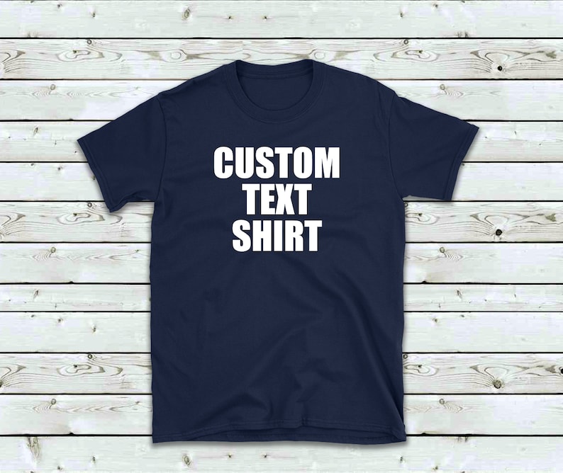 May include: A navy blue t-shirt with the text "CUSTOM TEXT SHIRT" printed in white on the front.