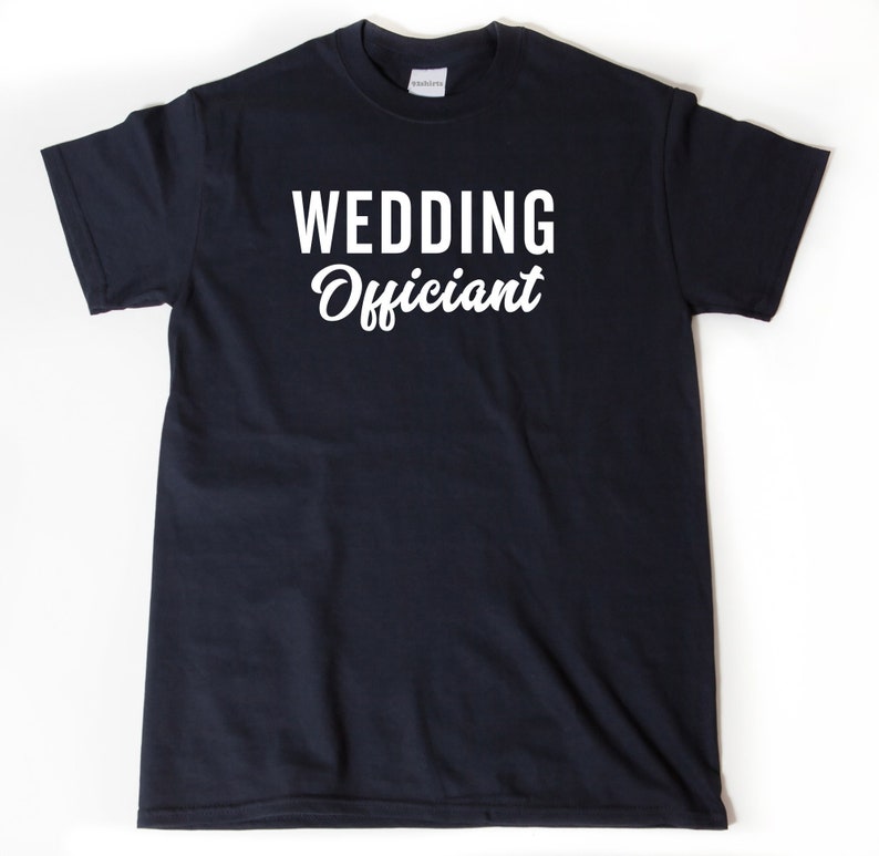 May include: A black t-shirt with white text that reads "Wedding Officiant" in a cursive font.