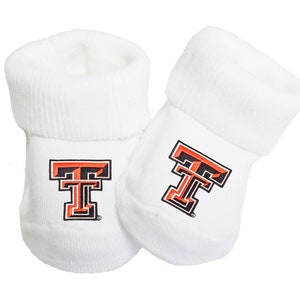 May include: White baby booties with a red and black embroidered "T" on each bootie.