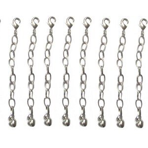 May include: Ten silver chain extenders with a lobster clasp on one end and a small ball on the other end.