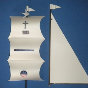 May include: A white paper model of a ship with a sail, a cross, a dove, and the text "Given unto Christ" and "Have Faith".