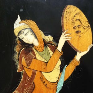 May include: An ornate painting on a black background depicts a woman in traditional attire holding a round mirror. The mirror reflects the image of a man. The woman's clothing is in shades of orange, yellow, and green.