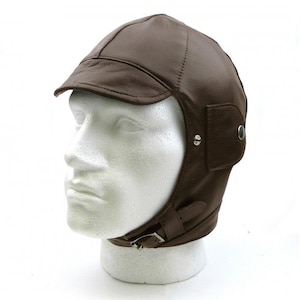 May include: A brown leather aviator hat with ear flaps and a buckle strap. The hat has a short brim and a button on the side.