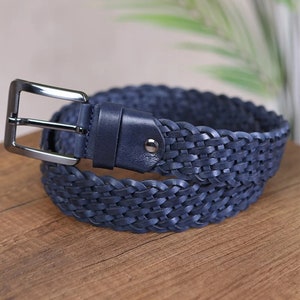 May include: A navy blue braided leather belt with a silver buckle.