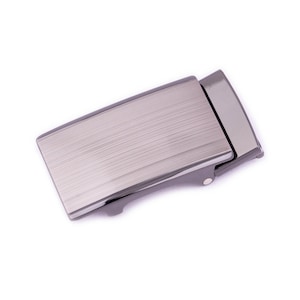 May include: A silver-toned metal belt buckle with a brushed finish. The buckle has a rectangular shape and a smooth, flat surface.