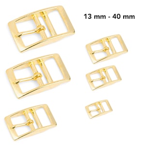 May include: Five gold-tone metal belt buckles in various sizes, ranging from 13 mm to 40 mm.