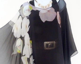 May include: A black sheer top with a white floral print. The top has a loose, flowing fit and a scoop neckline. It is made of a lightweight fabric that is perfect for warm weather.