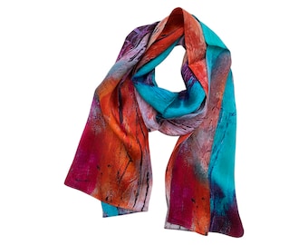 May include: A colorful silk scarf with abstract patterns in shades of orange, pink, turquoise, and purple.