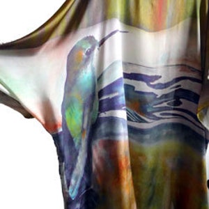 Pu&ograve; includere: Una blusa di seta fluida con un designo astratto colorato che presenta un uccello e motivi acquatici. La blusa &egrave; in tonalit&agrave; di verde, blu, giallo e arancione.