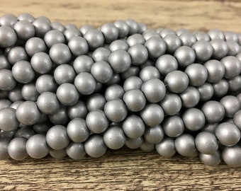 May include: A strand of silver round beads. The beads are smooth and have a matte finish.