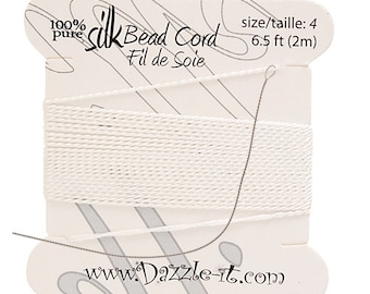May include: White silk bead cord on a card with the text "100% pure Silk Bead Cord Fil de Soie" and "size/taille: 4 6.5 ft (2m)" and the website address "www.Dazzle-it.com".