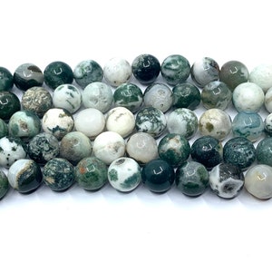 May include: A strand of green, white and grey agate beads. The beads are round and have a smooth, polished finish.