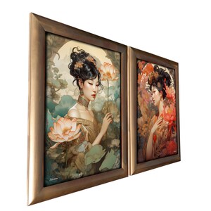 May include: Two framed paintings of women with flowers in their hair. The woman on the left is wearing a gold dress and holding a white lotus flower. The woman on the right is wearing a red dress and holding a pink lotus flower.