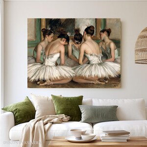 The image is a painting of five ballerinas in white tutus and green tutus, arranged in a group and facing each other.