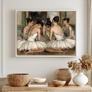 The image is a framed painting depicting a group of ballet dancers in white tutus and ballet slippers, arranged in a semi-circle on a stage.