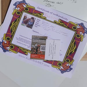 May include: Certificate of authenticity for an original acrylic painting by Ksenia Sarmatova. The certificate features a decorative border with a red, yellow, and blue design. The artist's signature is included, along with the title, size, medium, and year of the painting.