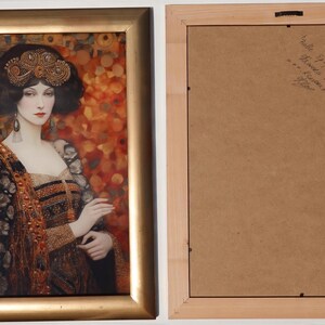 The image is a framed painting of a woman wearing an ornate, colorful dress with a headdress. The frame has a gold border and the painting is displayed on a white wall.