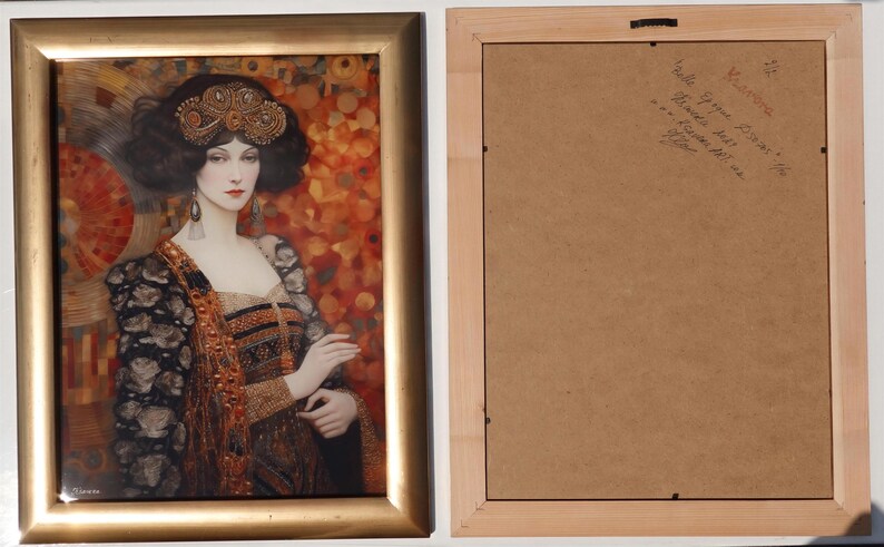 The image is a framed painting of a woman wearing an ornate, colorful dress with a headdress. The frame has a gold border and the painting is displayed on a white wall.