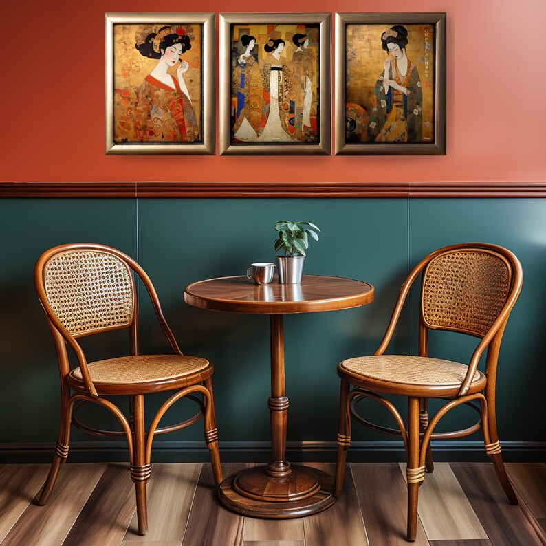 May include: Three framed paintings of women in traditional Japanese clothing, hanging on a red wall above a wooden table with two wicker chairs. The table has a wooden top and a pedestal base.
