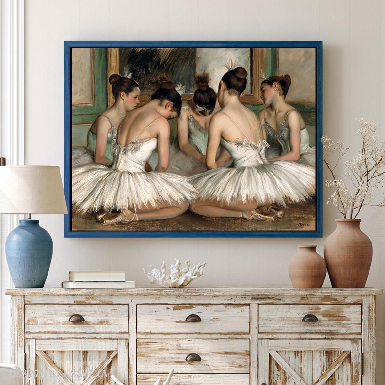 a framed painting of ballet dancers in white tutus and ballet slippers, arranged in a group and facing each other.
