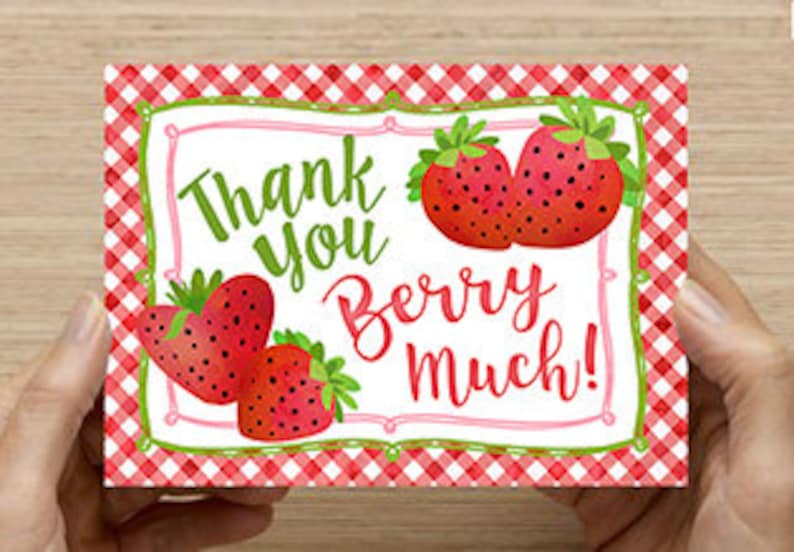 May include: Thank you berry much! Greeting card with a red and white gingham background and a white frame with the text "Thank you berry much!" and illustrations of red strawberries.