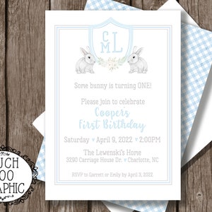May include: A blue and white gingham patterned invitation with a white border. The invitation is for a first birthday party for a baby named Cooper. The invitation features a shield with the initials "CML" and two bunnies. The text on the invitation reads "Some bunny is turning ONE! Please join to celebrate Cooper's First Birthday Saturday April 9, 2022 2:00PM The Lewenski's Home 3290 Carriage House Dr. v Charlotte, NC RSVP to Garrett or Emily by April 3, 2022"