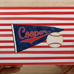 May include: A red, white, and blue striped background with a blue pennant that says "Cooper" in red lettering. A baseball is in the lower right corner of the image.