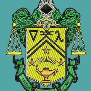 May include: An embroidered crest featuring a yellow shield with a black chevron, three stars, and a golden oil lamp. Above the shield is a silver helmet with green scrollwork. Two golden scales flank the shield, and a green banner reads Delta Phi Lambda.