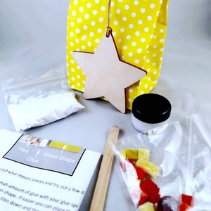 May include: A craft kit for making a mosaic star ornament. The kit includes a wooden star, a bag of colorful mosaic tiles, a small jar of glue, a wooden craft stick, and instructions.