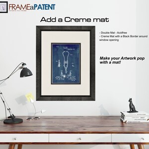 May include: A framed blue and white patent drawing of a stethoscope. The frame is black and has a creme mat with a black border around the window opening. The text "Add a Creme mat" and "Make your Artwork pop with a mat!" is visible in the image.