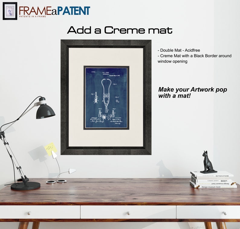 May include: A framed blue and white patent drawing of a stethoscope. The frame is black and has a creme mat with a black border around the window opening. The text "Add a Creme mat" and "Make your Artwork pop with a mat!" is visible in the image.