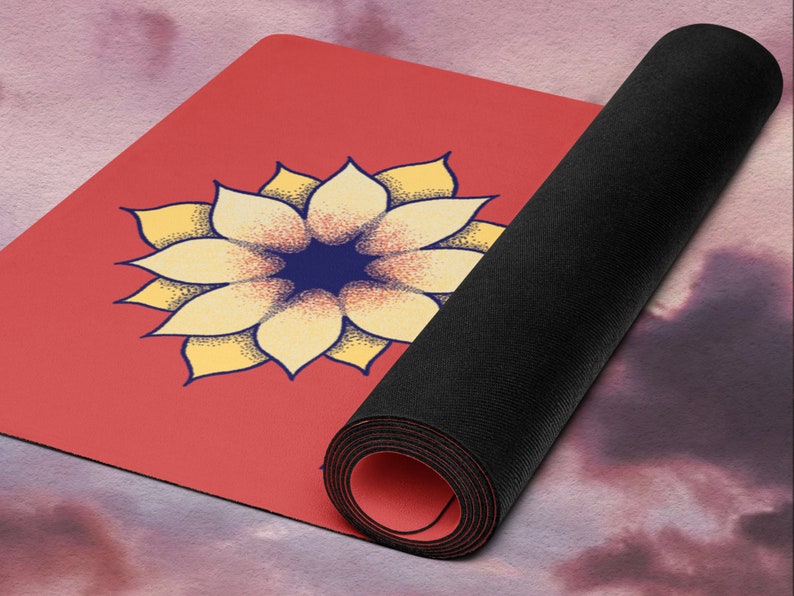 May include: A red yoga mat with a yellow and blue flower design. The mat is rolled up and the end is visible.