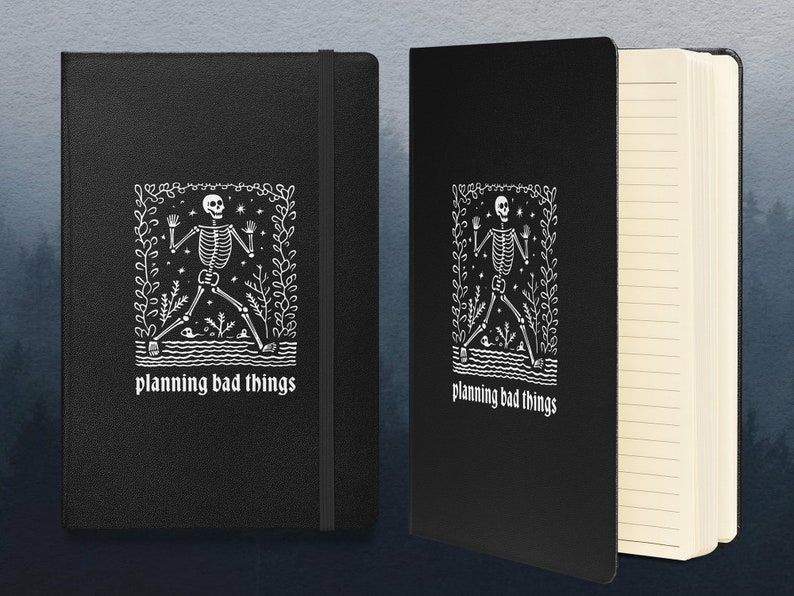 May include: Black notebook with a white skeleton illustration and the text "planning bad things". The notebook has lined pages.