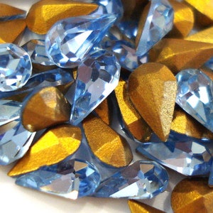50 Vintage Swarovski Light Sapphire Crystals Gold Foil. 29pp