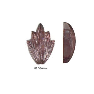 May include: Two polished, reddish-brown gemstone cabochons. One is a stylized leaf shape, the other a half-oval. The leaf-shaped stone has a textured, fan-like pattern. The text "MrStones" is at the bottom.