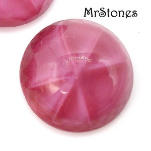May include: Close-up of two round, polished, pink gemstones. The gemstones have a star-like pattern radiating from the center. The text "MrStones" is in the upper right corner. The gemstones are set against a white background.