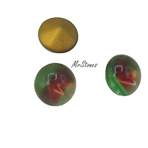 May include: Three glass marbles, one gold, one green with red and orange swirls, and one green with red and orange swirls.