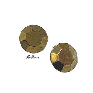 May include: Two round, faceted metallic stones with a muted gold finish and a geometric, multi-sided surface texture. The text MrStones is printed in a black, cursive font between the two stones, which feature a reflective, polished appearance.