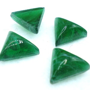 Puede incluir: Cuatro cabujones triangulares de vidrio verde con un patrón de espiral.