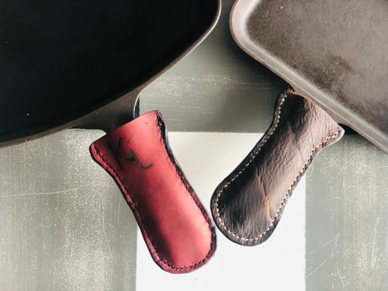 Burgundy oiled leather that is hand cut, punched and stitched, to perfectly fit those classic cast iron pans. They are durable and age well over time. Simply wipe with a damp cloth and let dry thoroughly before the next use.