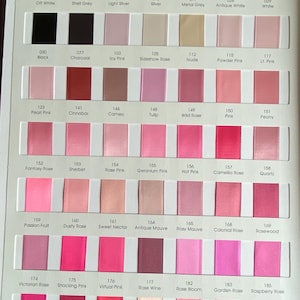 May include: A colour chart showing ribbon swatches in pink, grey, and white hues. Each swatch is labelled with a number and colour name, from "Off White" to "Raspberry Rose". The ribbons are arranged in rows and columns, providing a comprehensive colour selection.