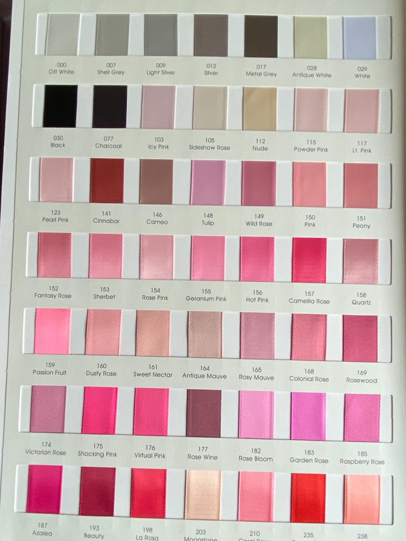 May include: A colour chart showing ribbon swatches in pink, grey, and white hues. Each swatch is labelled with a number and colour name, from "Off White" to "Raspberry Rose". The ribbons are arranged in rows and columns, providing a comprehensive colour selection.
