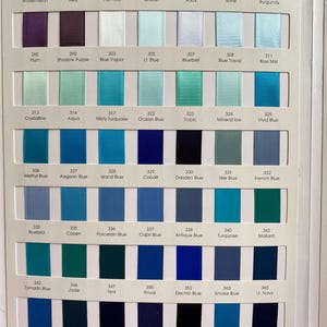 May include: A colour chart showing a range of ribbon colours, each with a name and number. The ribbons vary from red and pink to blue and green, with shades of purple and teal. The chart is arranged in rows and columns.