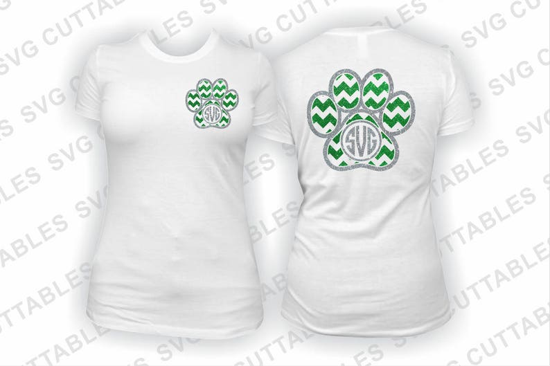 May include: Two white t-shirts with a green and silver paw print design. The paw print has a chevron pattern and a monogram in the center. The monogram is the letters "SVG".
