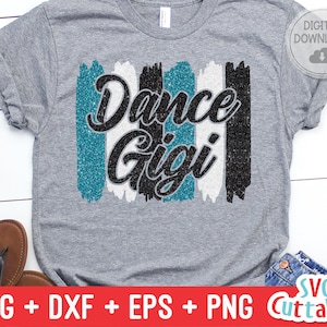 May include: A gray t-shirt with a glittery design that says "Dance Gigi" in black and teal lettering. The design is made up of vertical stripes of black, white, and teal.