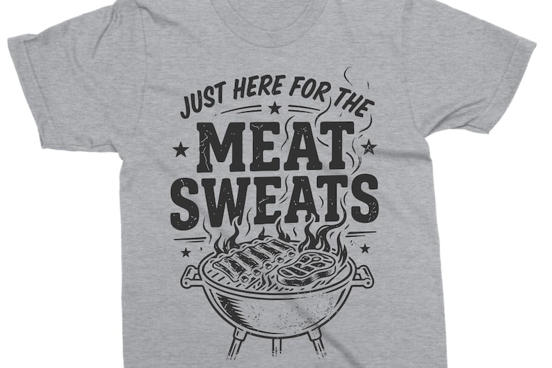May include: A gray t-shirt with the phrase "JUST HERE FOR THE MEAT SWEATS" in black, above a graphic of a grill with ribs and steak. The shirt is a casual wear item.