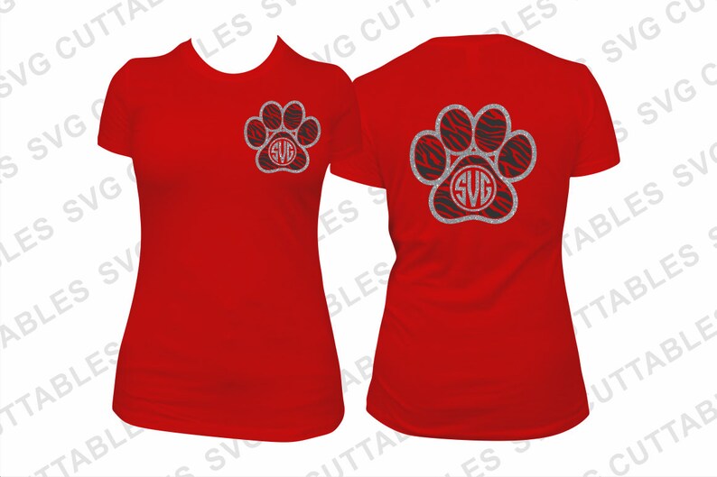 May include: Two red t-shirts with a silver glitter paw print design. The paw print has a black and white zebra print inside and the letters "SVG" in the center.
