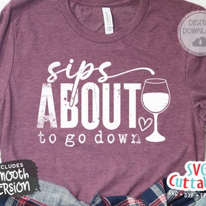 May include: A maroon t-shirt with a white graphic that says "sips about to go down" with a wine glass and heart design. The graphic has a distressed look. The shirt is a digital download and includes a smooth version.