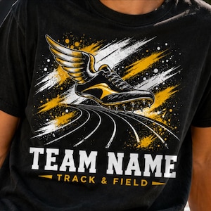 May include: Black t-shirt featuring a track and field design. The graphic includes a winged track shoe in black and gold, with the words "TEAM NAME" and "TRACK & FIELD" in white and gold.